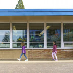    Students at Ellsworth Elementary School in Vancouver, Wash., wear masks as they walk between c...