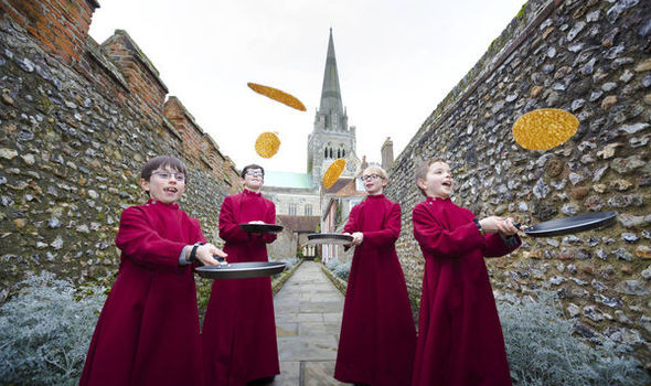 Young choristers flipping pancakes on Pancake Tuesday