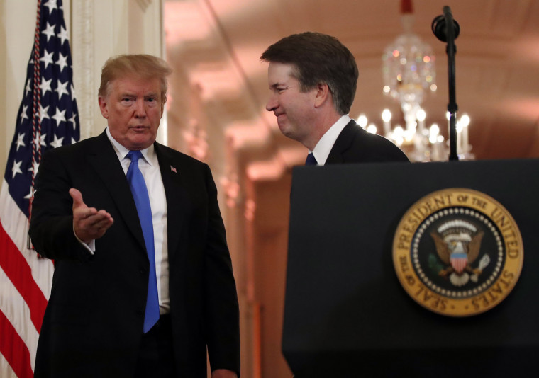 President Donald Trump gestures with Judge Brett Kavanaugh his Supreme Court nominee, in the East Room of the White House, Monday, July 9...