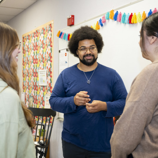 Graduate students engage with each other at a K-12 school.