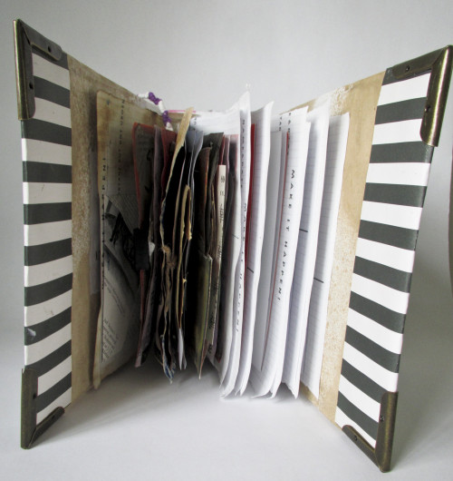 Title: Grief Junk Journal, openDimensions: 3.5x8.3x7.5Materials: Cardboard, fabric, magazine cutouts, coffee-stained paper, metal corner,...