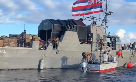 A fishing boat arrives from O'ahu, bringing supplies donated directly from the people of O'ahu.