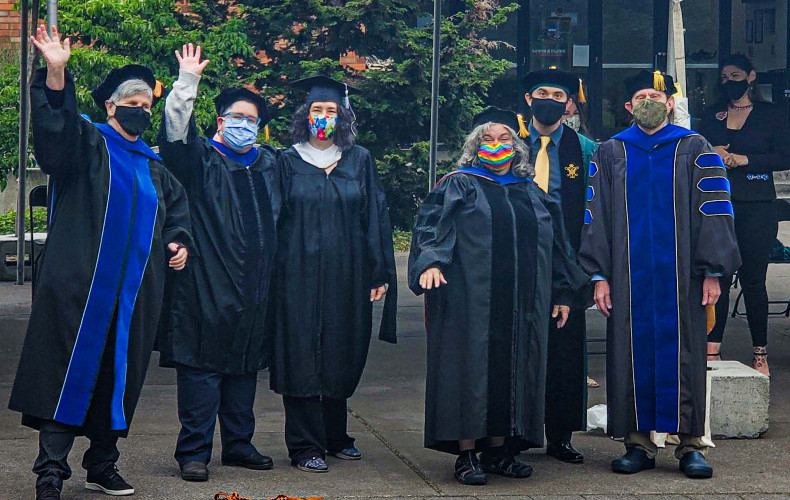 Graduate faculty celebrate the graduating class of 2021 at the drive-thru commencement ceremony.